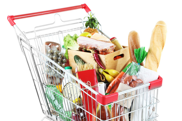 Shopping cart full with various groceries isolated on white  - Foto, immagini