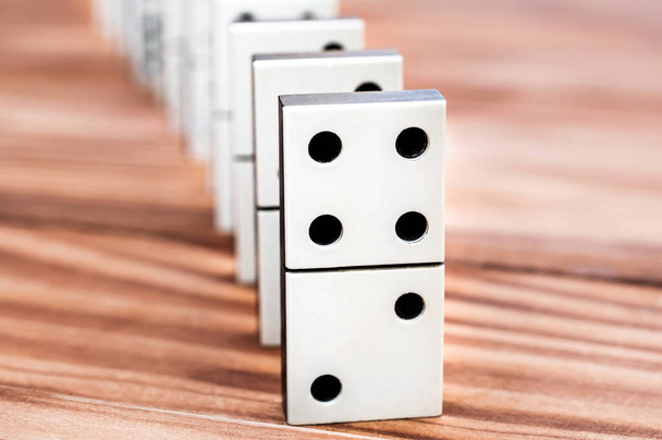 Row of dominoes on the wooden table. - Photo, Image