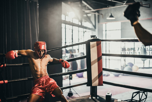 Boxer use various punch combinations, including the jab, hook, uppercut, cross, swing, straight. Getting in close to make opponent on ropes and knockout. Boxing champions win the round in boxing ring - Fotoğraf, Görsel