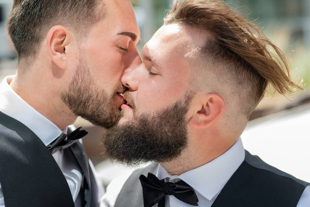 Gay kiss on wedding. Marriage gay couple tender kissing. Close up portrait of gay kissed. Portrait of gay couple in love on wedding day - 写真・画像