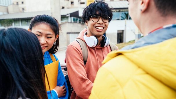 Group of multiracial students going to school together. Laughing friends walking outdoors - Photo, image