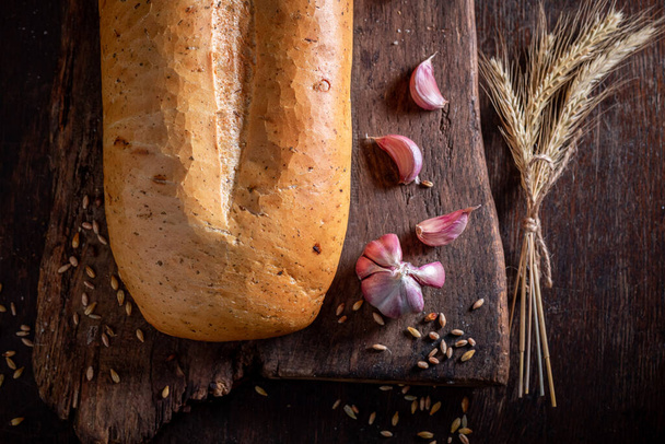 Tasty and aromatic bread seasoning with garlic olive oil. Loaf of bread with garlic oil. - Φωτογραφία, εικόνα
