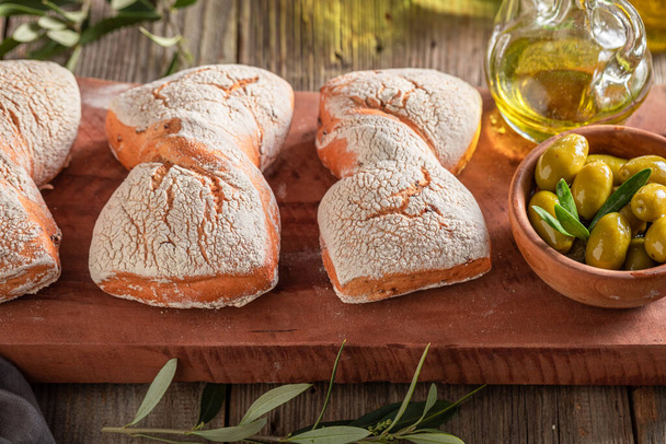 Tasty rolls as traditional baked goods in Tuscany. Rolls with green olives. - Fotoğraf, Görsel