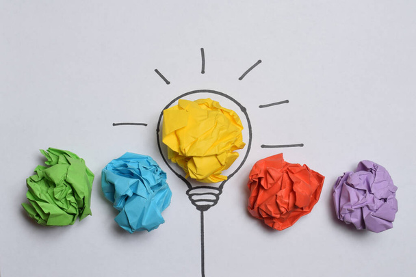 Colored crumpled paper balls and light bulb as creative concept - Photo, Image