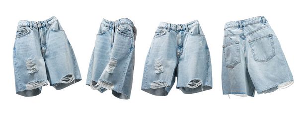 Ripped handmade jeans shorts floating from different sides on light gray background. Fashionable female trendy denim clothes. Cut out objects for design. Creative concept Summer Women's Clothing. - Photo, Image