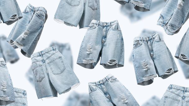 Ripped jeans shorts vliegen op blauwe achtergrond. Vrouwelijke modieuze denim doek. Reclame voor dames trendy winkel, blog. Onderwerp Zomer Vrouwenkleding. Creatief sjabloon voor design.Mock up. Patroon - Foto, afbeelding