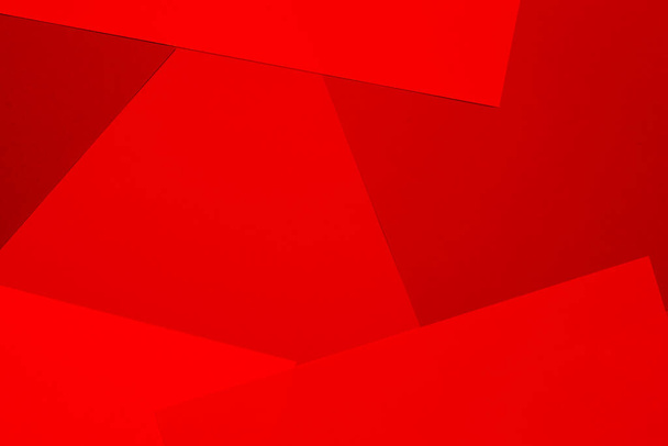 Sheets of colored paper in red shades as a background. Mockup, copy space. Geometric print. - Photo, Image