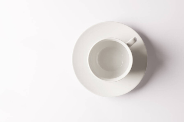 Life begins once Ive had a cuppa. Closeup shot of a cup and saucer against a white background - Фото, зображення