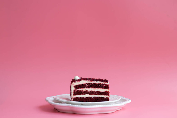 Red Velvet Cake on white ceramic plate , Pink background - Fotoğraf, Görsel
