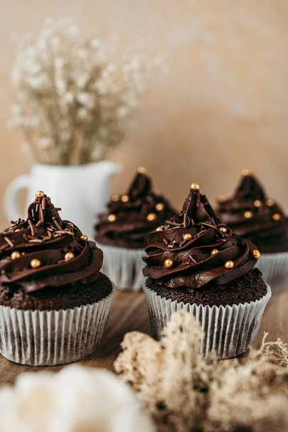 Delicious homemade chocolate cupcakes on nicely decorated  table. Sweet food concept. - Fotoğraf, Görsel