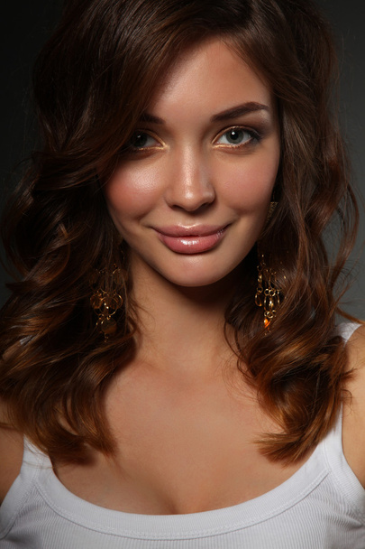 Portrait of beautiful young woman face. Isolated on dark background - Zdjęcie, obraz