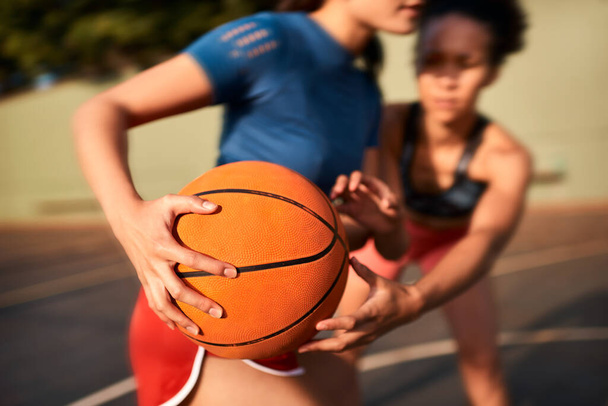 Keeping my stance strong. an unrecognizable sportswoman holding the basketball away from her opponent during the game - Foto, Imagem
