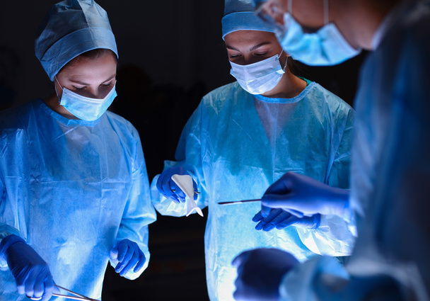 Team surgeon at work in operating - Фото, изображение