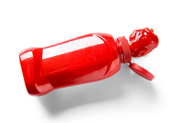 Ketchup exprimido de la botella sobre fondo blanco - Foto, imagen