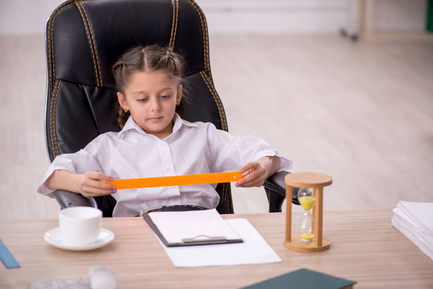 Little girl sitting in the classroom in time management concept - Photo, image