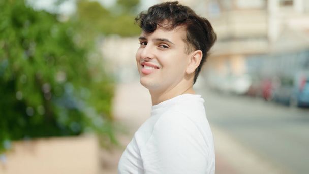 Non binary man smiling confident standing at park - 写真・画像