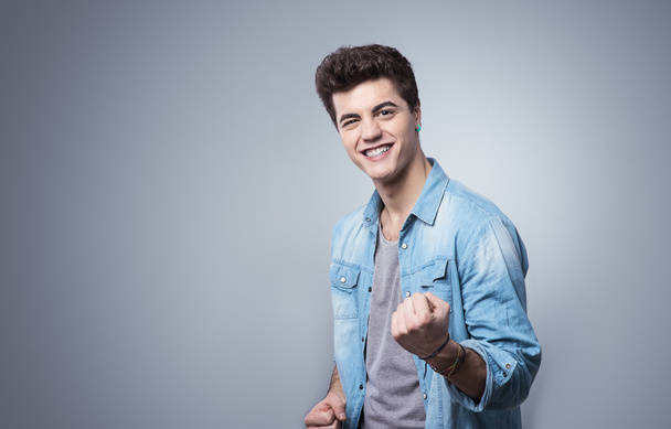 Guy smiling and showing fists - Foto, Imagem