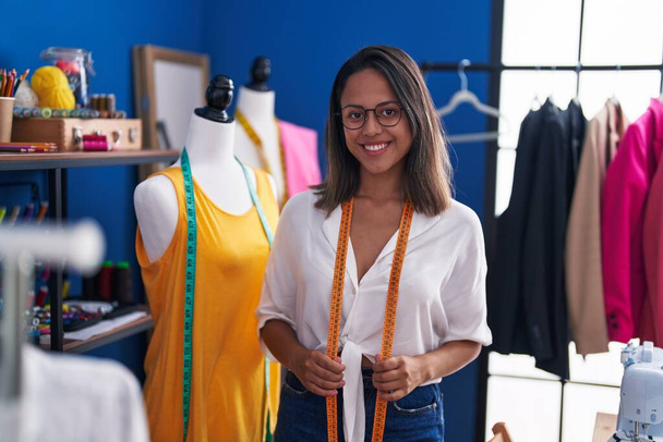 Young hispanic woman tailor smiling confident standing at sewing studio - Foto, Imagem