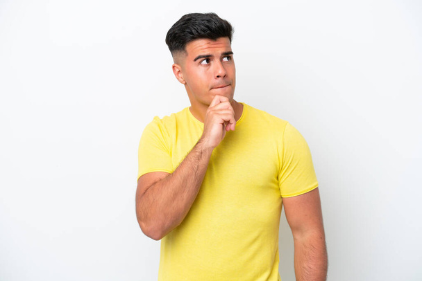 Young caucasian handsome man isolated on white background having doubts and thinking - Φωτογραφία, εικόνα