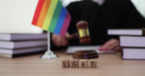 Prawa i prawo osób LGBT oraz drewniane klocki z tekstem LGBTQ na tle młotka sędziego. Symbol prawa i sprawiedliwości w przyjmowaniu par tej samej płci - Materiał filmowy, wideo