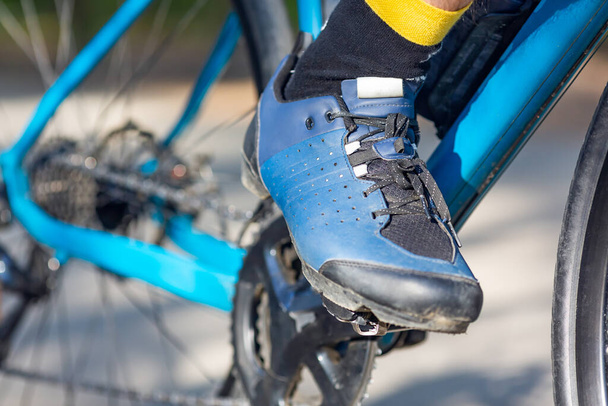 Close-up - voet van een sporter tijdens een wielerwedstrijd. Regelmatige training is de sleutel tot overwinningen, niet alleen in de sport, maar ook in het leven. - Foto, afbeelding
