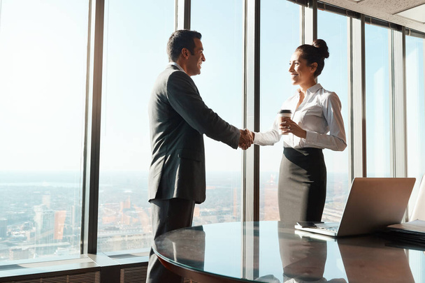 Networking is such a powerful tool in business. two businesspeople shaking hands in an office - Photo, Image