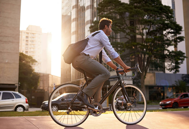 Morning, bicycle and business man in city for moving, commute and carbon neutral transportation. Travel, sustainability and cycling with male employee in urban town for journey, energy and transit. - 写真・画像