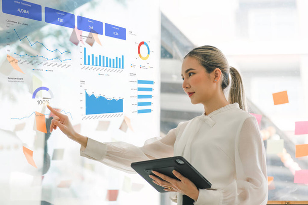 タブレット、ビジネスウーマンまたは会計士を使用して、財務投資、ビジネス、およびマーケティングの成長をデータグラフで分析しています。この分析は、会計、経済学、商業的概念に関連している。 - 写真・画像