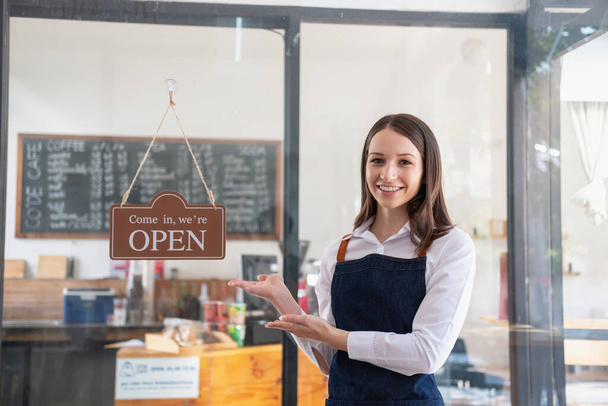 Portrait of a woman, a coffee shop business owner smiling beautifully and opening a coffee shop that is her own business, Small business concept.	 - Photo, image