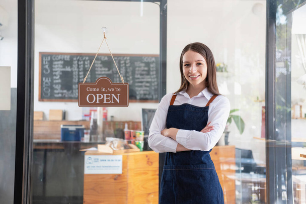 Portrait of a woman, a coffee shop business owner smiling beautifully and opening a coffee shop that is her own business, Small business concept.	 - Photo, Image