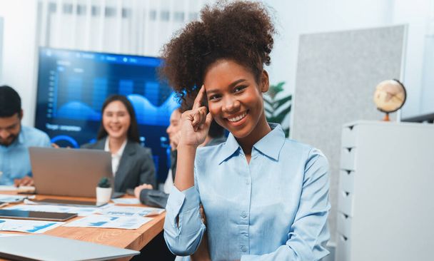 Portrait of happy young african businesswoman with group of office worker on meeting with screen display business dashboard in background. Confident office lady at team meeting. Concord - Fotoğraf, Görsel