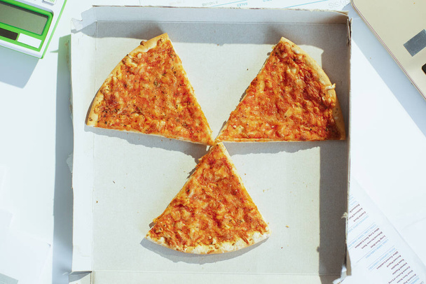 Upper view of pizza at the table in radiation sign. - Foto, Imagem