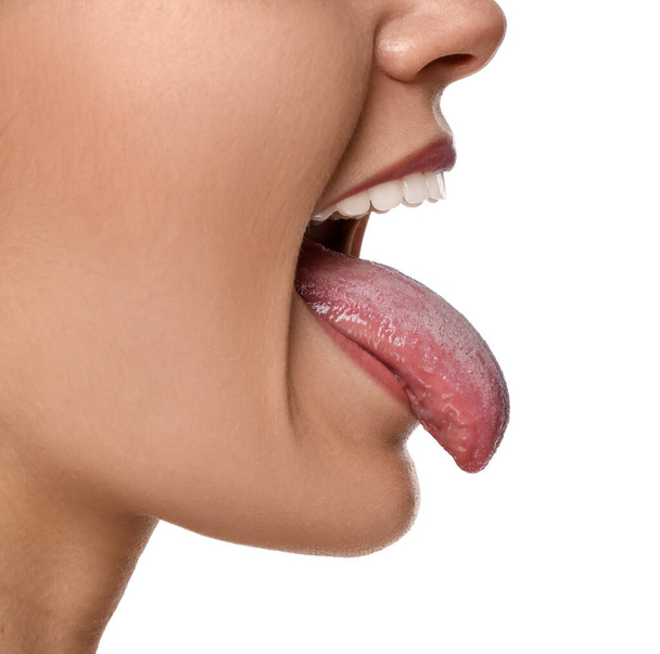Happy young woman showing her tongue on white background, closeup - Photo, Image