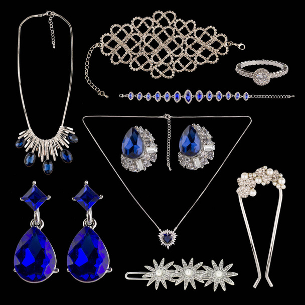 Set of jewelry on a black background. Earrings, hairpins, chains, necklaces. - Zdjęcie, obraz