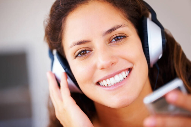 Pretty woman listening to music. Closeup of pretty woman listening to music on headphones - Фото, зображення