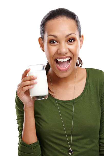 Nada como un vaso de leche fría. Retrato de una joven atractiva que se ve emocionada por su vaso de leche aislada en blanco - Foto, Imagen