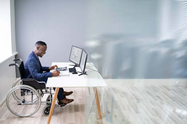 Disabled African Accountant Working On Computer In Wheelchair - Φωτογραφία, εικόνα