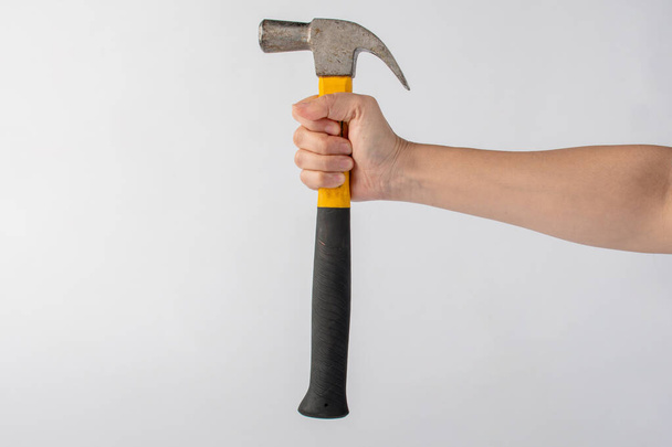 Hand with hammer on white background. - Foto, Bild