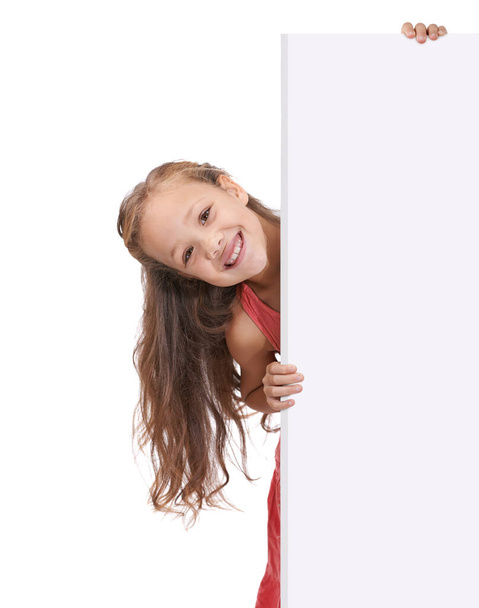 Endorsing your product. A little girl holding a blank placard for copyspace - Foto, Imagen
