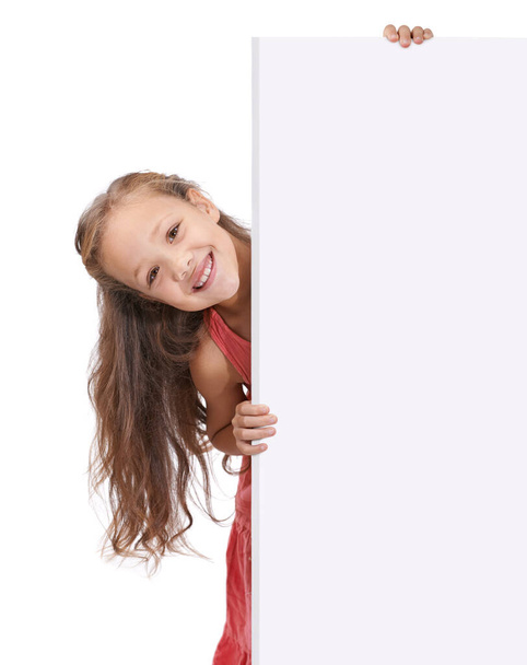 Put your message here. A little girl holding a blank placard for copyspace - Фото, изображение