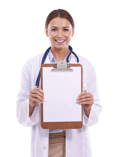 Keeping track of her patients progress. Portait of a beautiful young woman holding up a clipboard and smiling against a white background - Fotoğraf, Görsel
