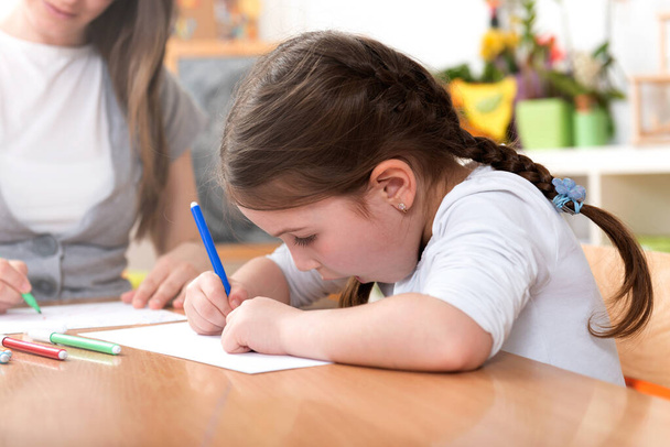 Teacher and Cute Little Girl Drawing Lessons Art Class - Фото, зображення