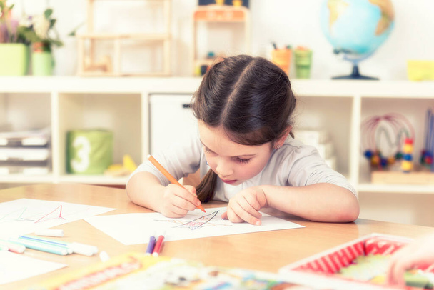 cute little girl drawing  in kindergarten classroom - 写真・画像