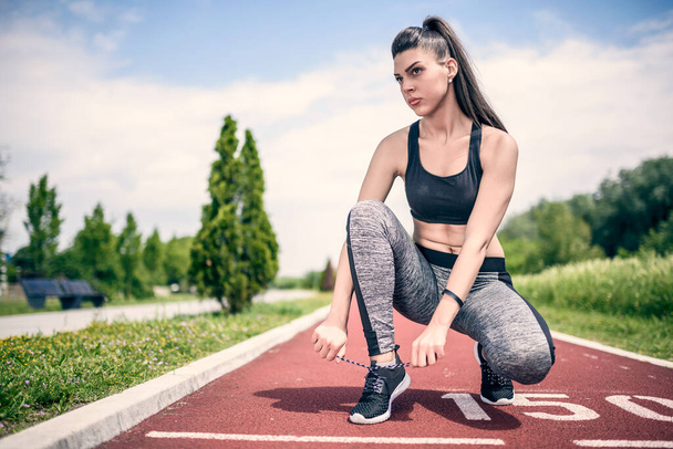 athletic female athlete runner on stadium track - Zdjęcie, obraz