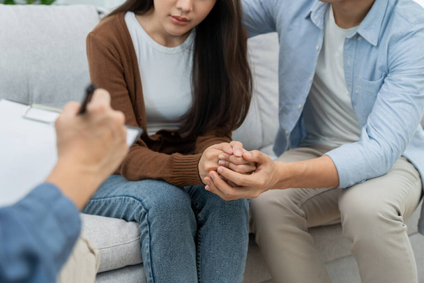 Couple hold hand support each while discussing family issues with psychiatrist. Husband encourages and empathy wife suffers depression. psychological, save divorce, Hand in hand together, trust, care - Foto, afbeelding