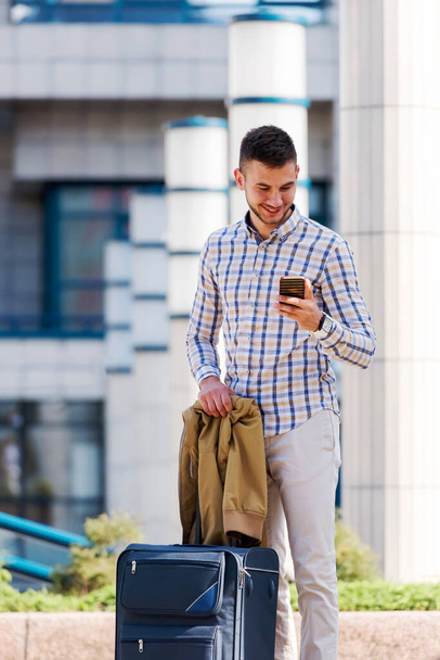 young man with mobile phone outdoors  - Photo, image