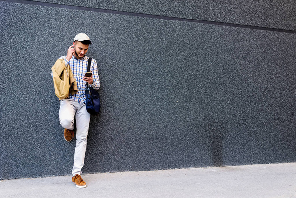 young man with mobile phone outdoors  - Foto, imagen