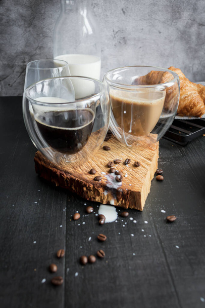 Coffee with milk. Morning. On a dark background. Breakfast - 写真・画像