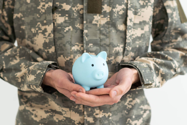 Soldiers Hand Holding Pink Piggy Bank. Save Income. - Photo, Image