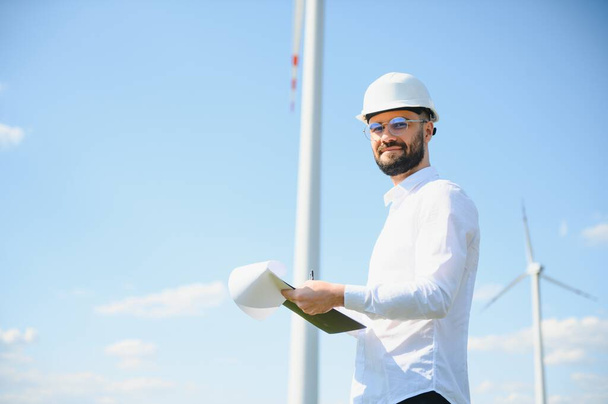 Windmill turbine maintenance engineer standing at wind farm - Fotografie, Obrázek